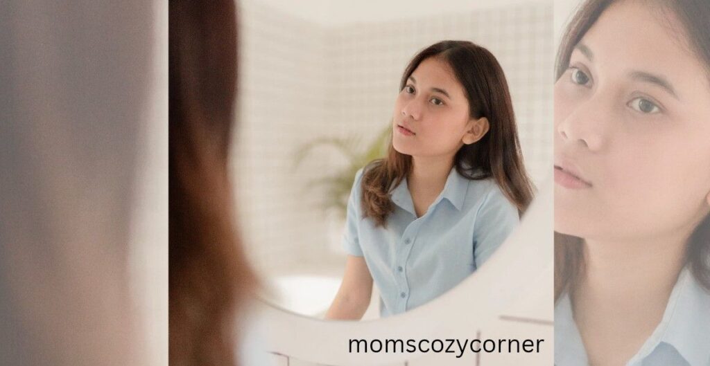 A woman looking at her reflection in a mirror, preparing to start her day.