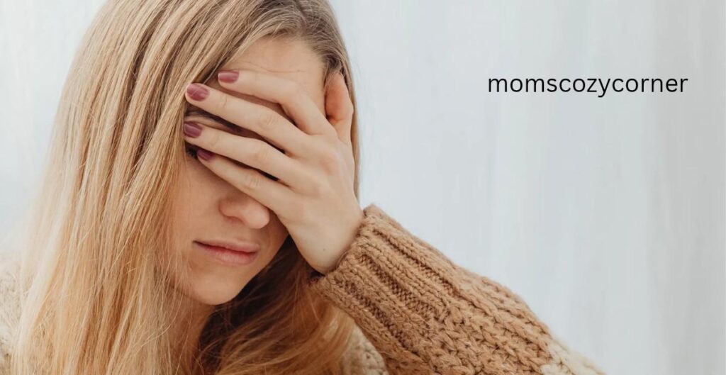 A woman covering her face with her hand to show how mothers feel stressed.