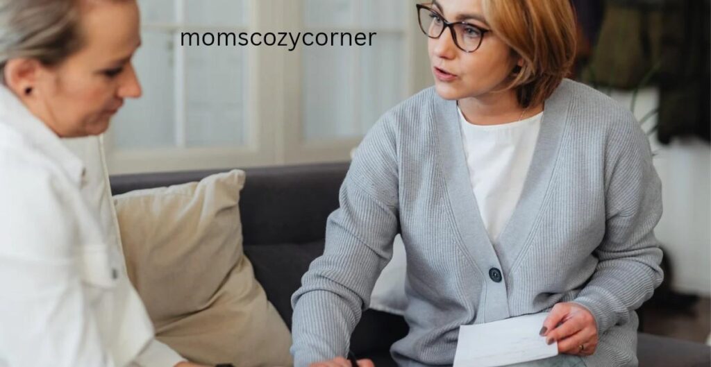 Two women having a supportive professional conversation on a couch.