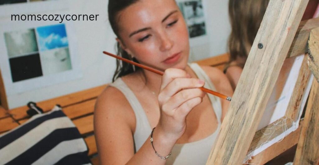 woman reflecting and reconnecting with herself through a creative moment to feel like herself again