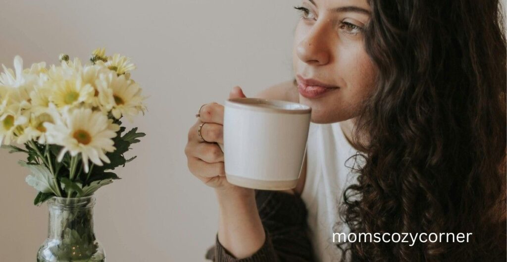 Woman calmly drinking coffee in a quiet moment reflecting on self-love and rewiring her mindset